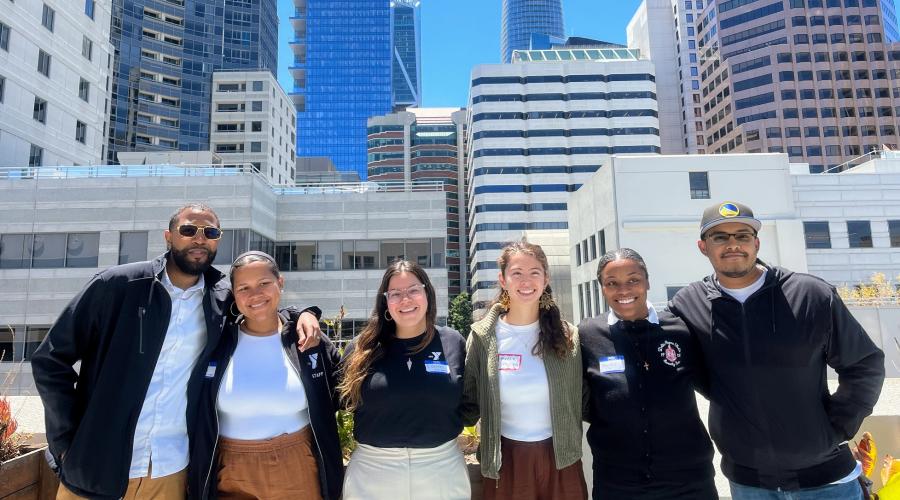 Members of the UCSF-YMCA Youth Research Advisory Council pose in front of the San Francisco skyline. 