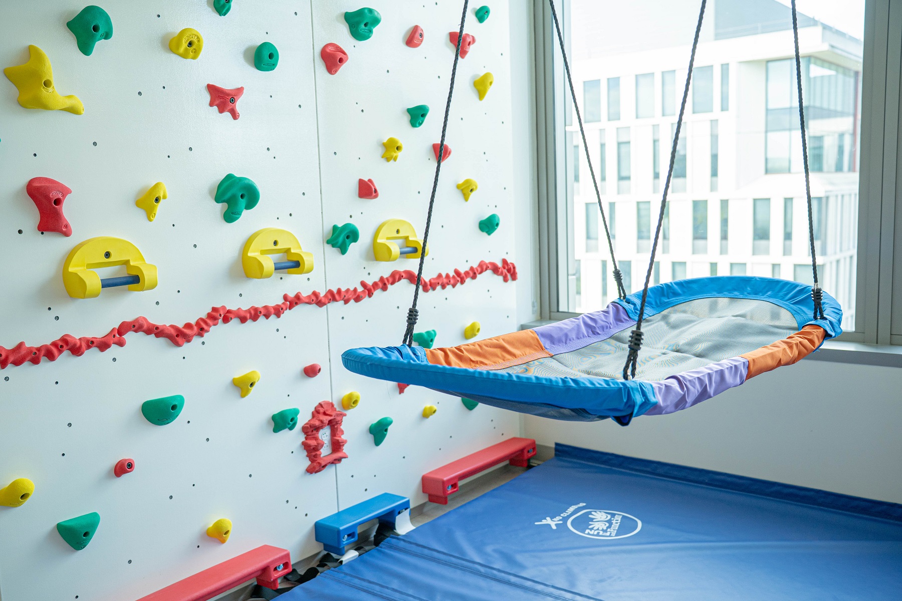 The Center includes a climbing wall to help patients build strength and confidence