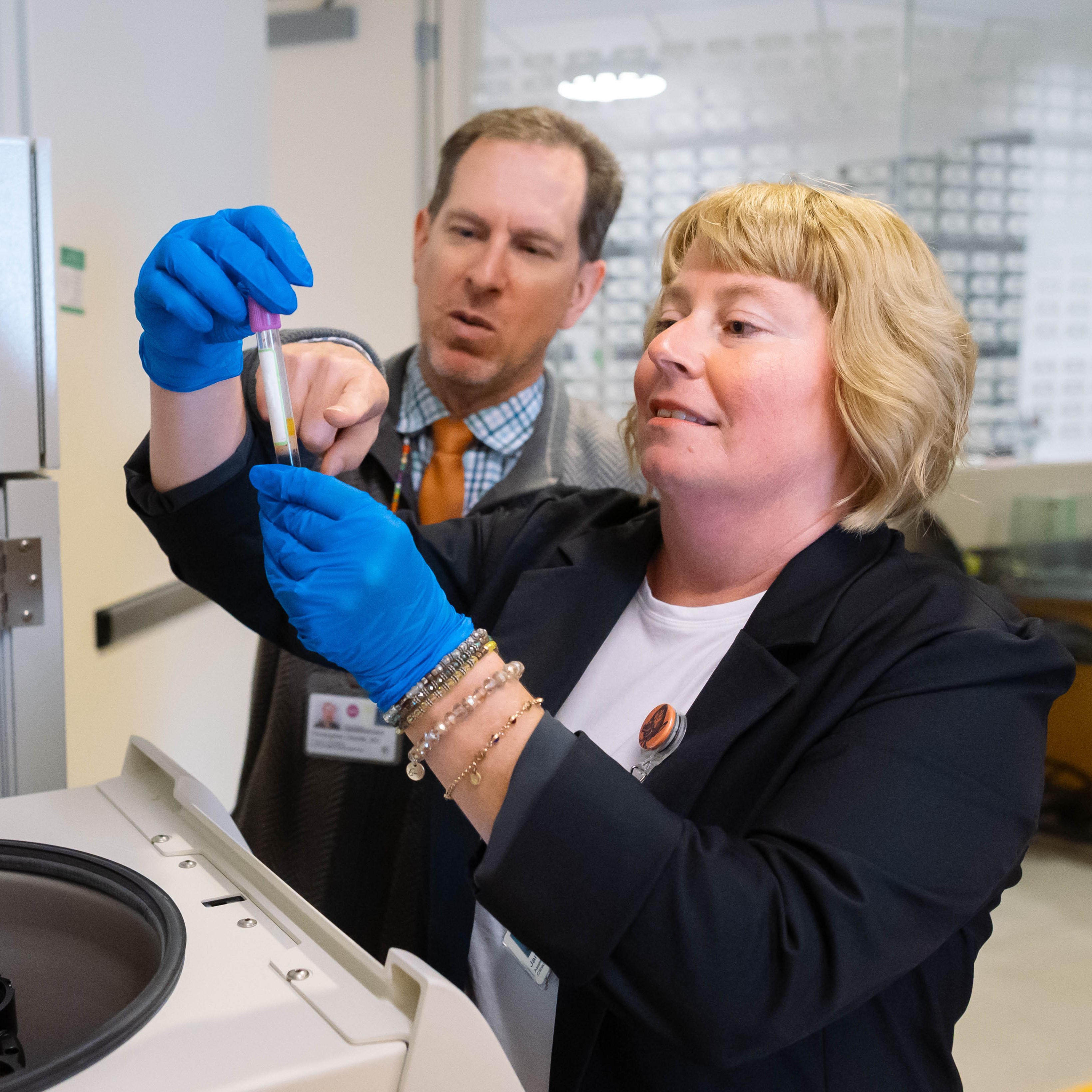 Christopher Dvorak, MD and Janel Long-Boyle, PharmD, PhD, analyze a patient's blood sample. Photo by Susan Merrell. 