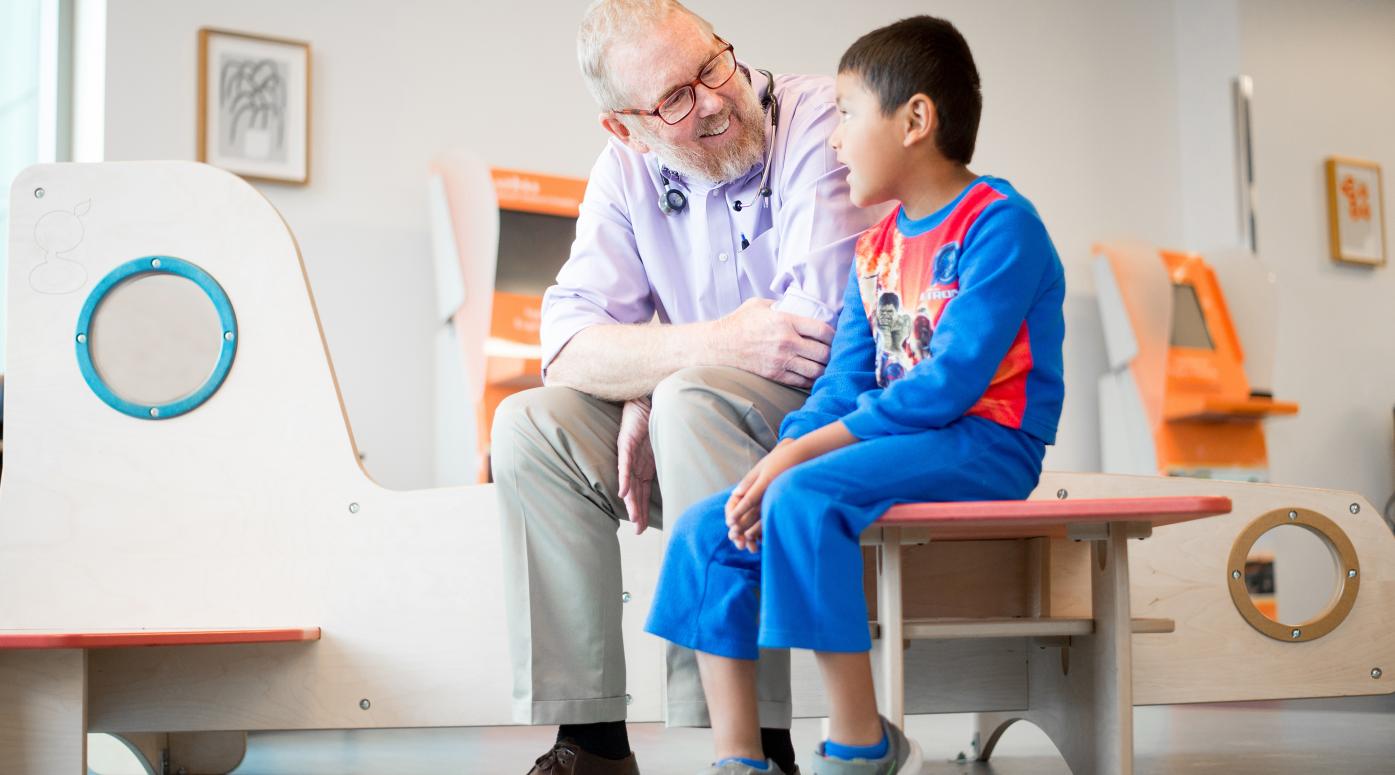 Physician sits with child