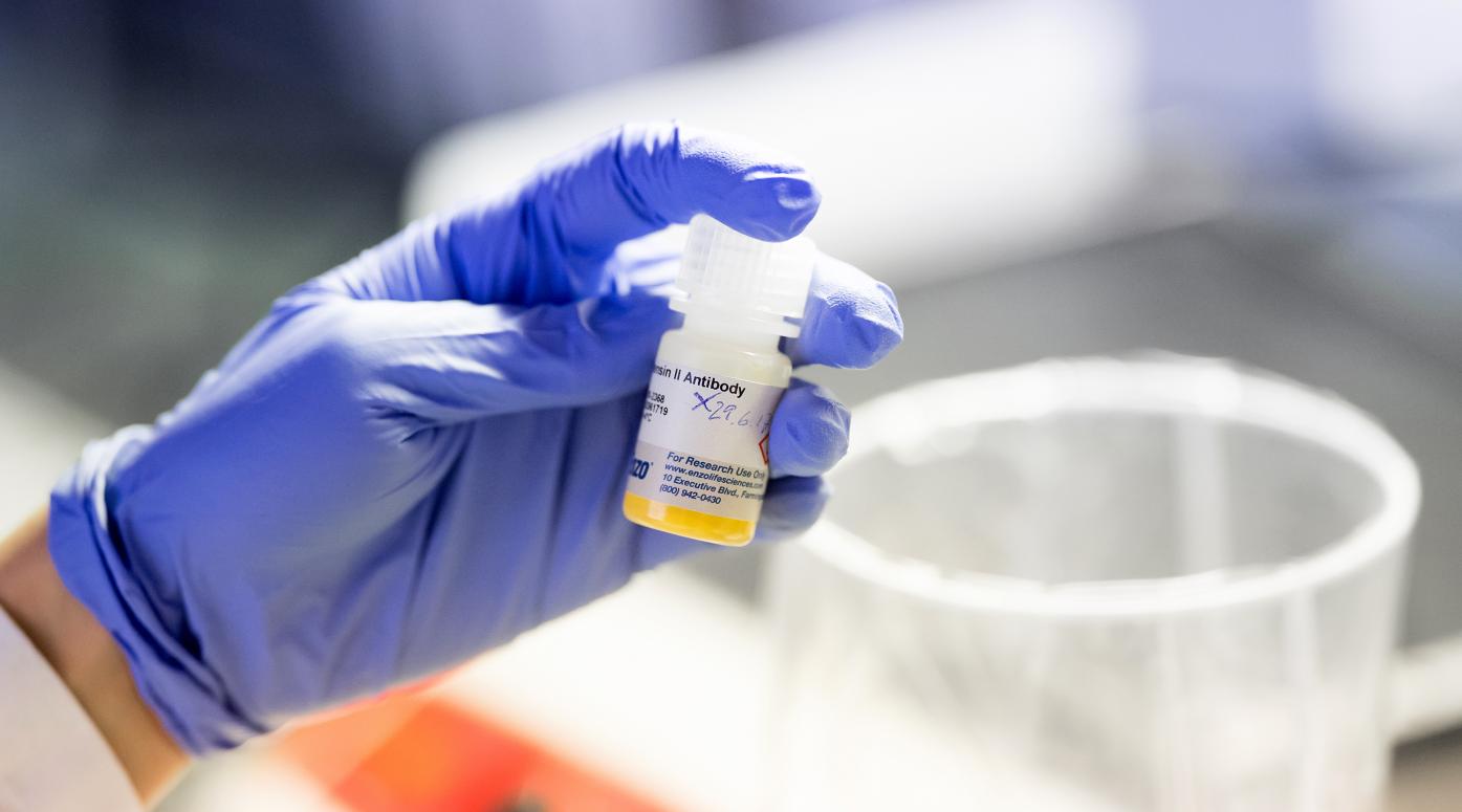 Lab technician holds a sample