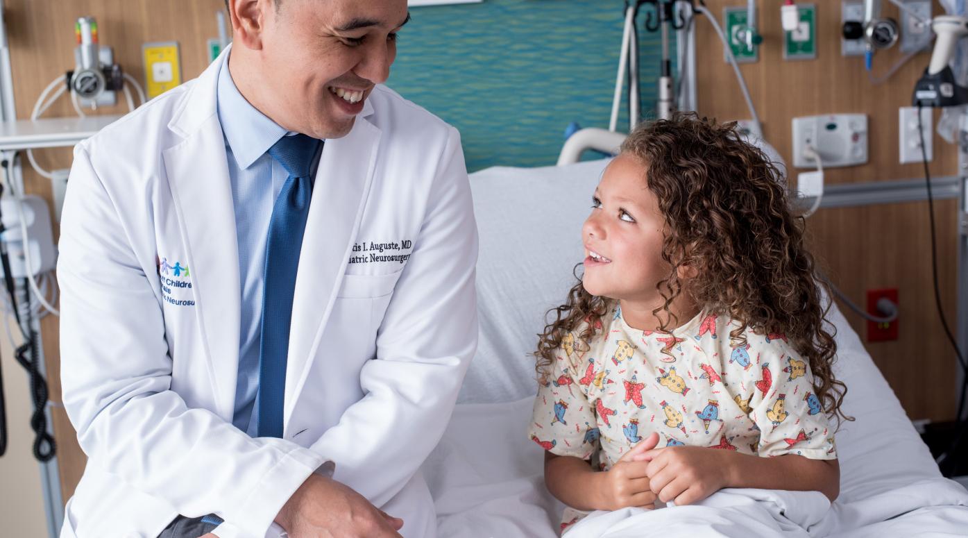 Child patient sits with doctor 