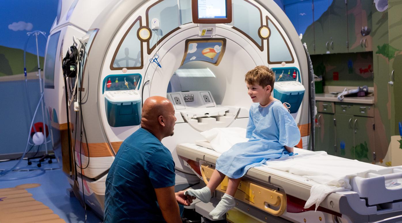 Doctor talking to patient near MRI machine