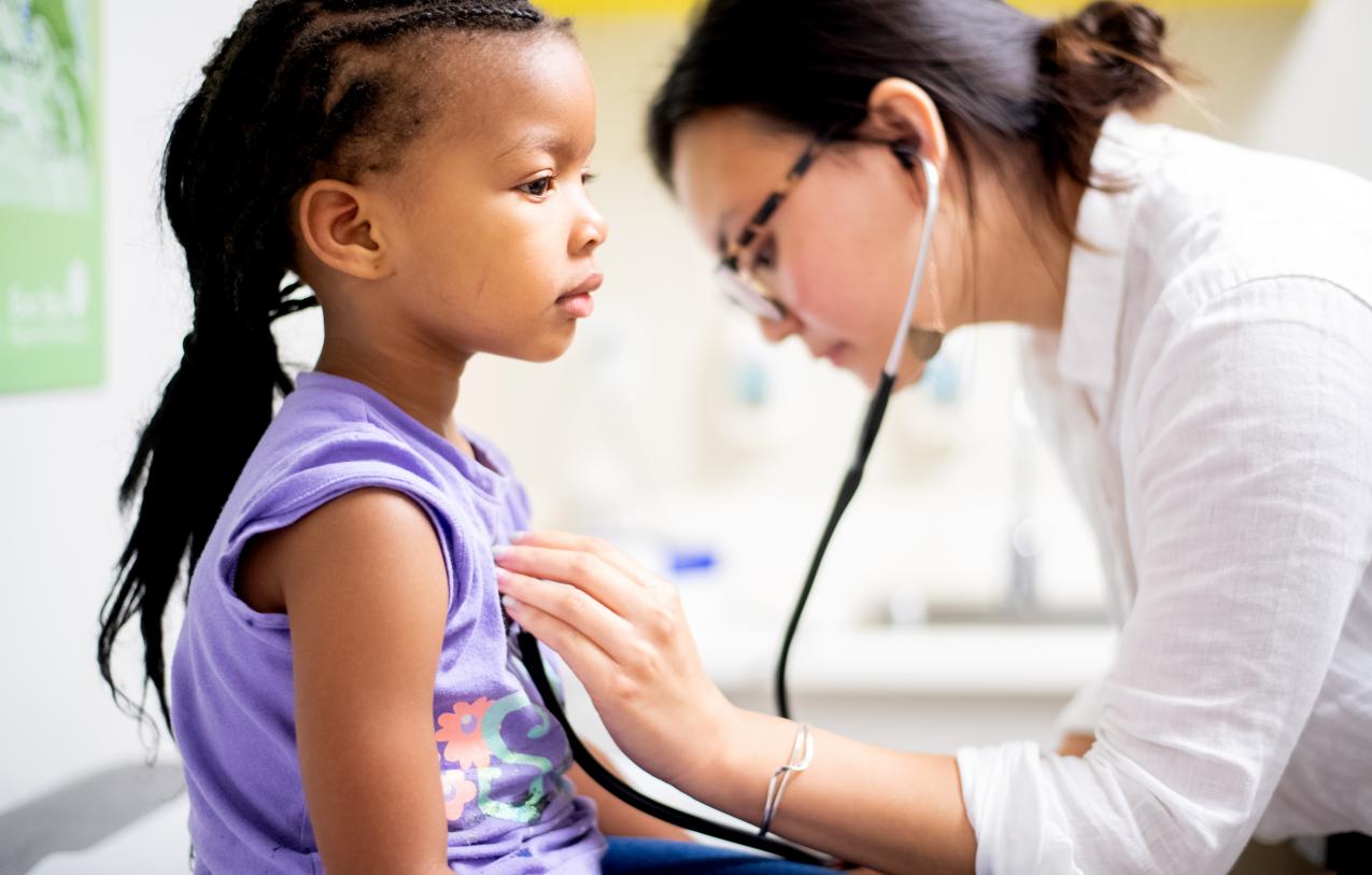 Doctor examines child with a stethoscope 