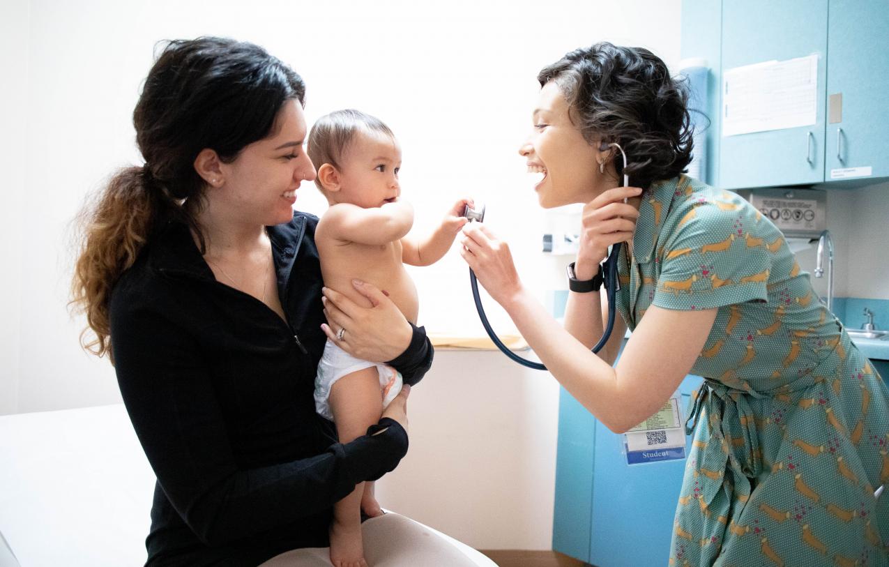 Pediatrician examines baby