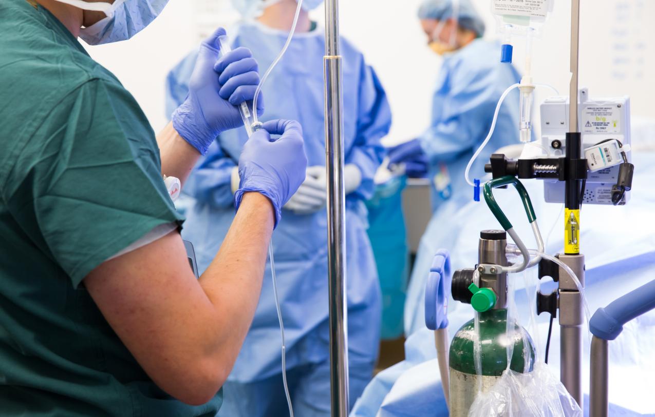 Anesthesiologist prepares an IV