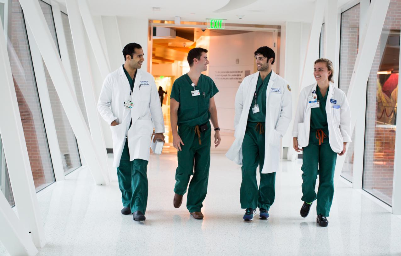 Four doctors walking through a hallway