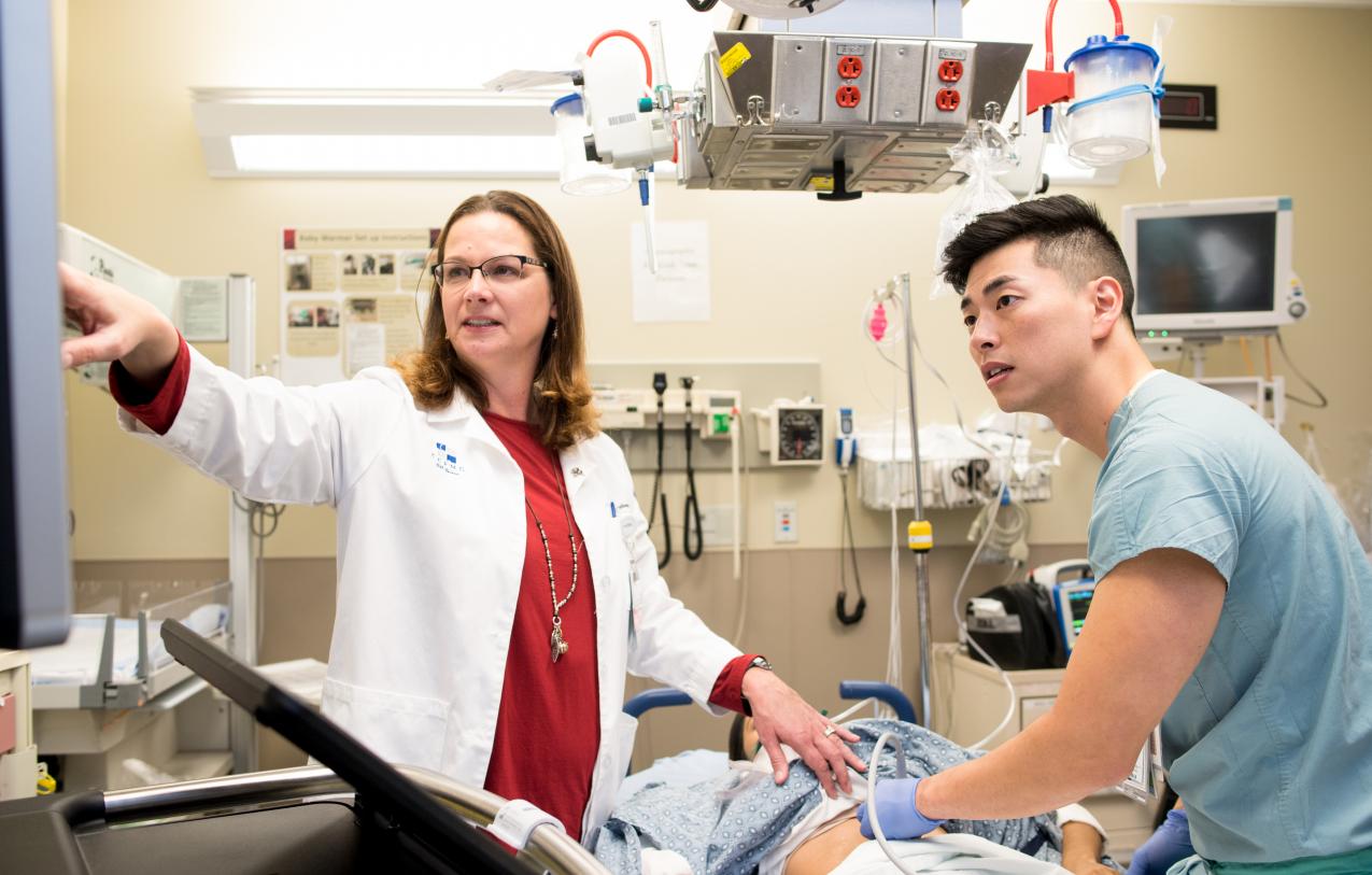 2 doctors working on a patient