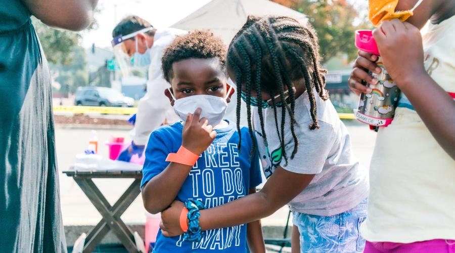 Two children in PPE masks