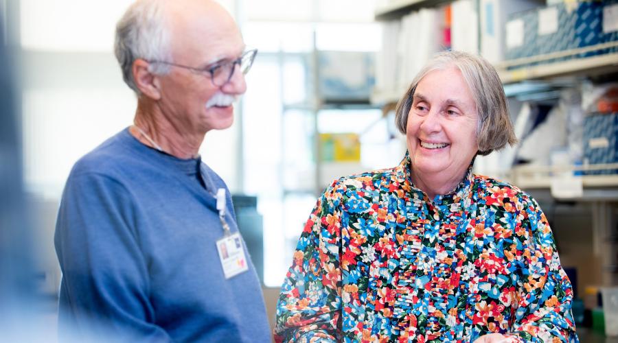 Mort Cowan and Jennifer Puck talk in the lab