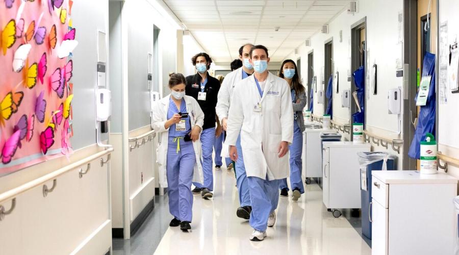 Doctors walk down a hospital hall 