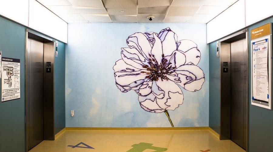 A flower mural decorates a children's hospital hallway 