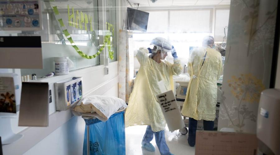 A nurse gets ready to attend to a patient