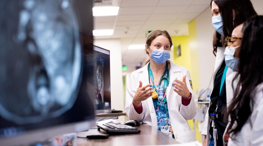 A physician looks at an MRI with trainees