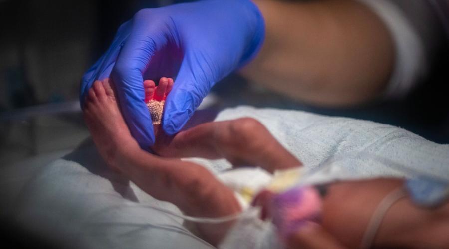 A nurse cares for a newborn in the NICU