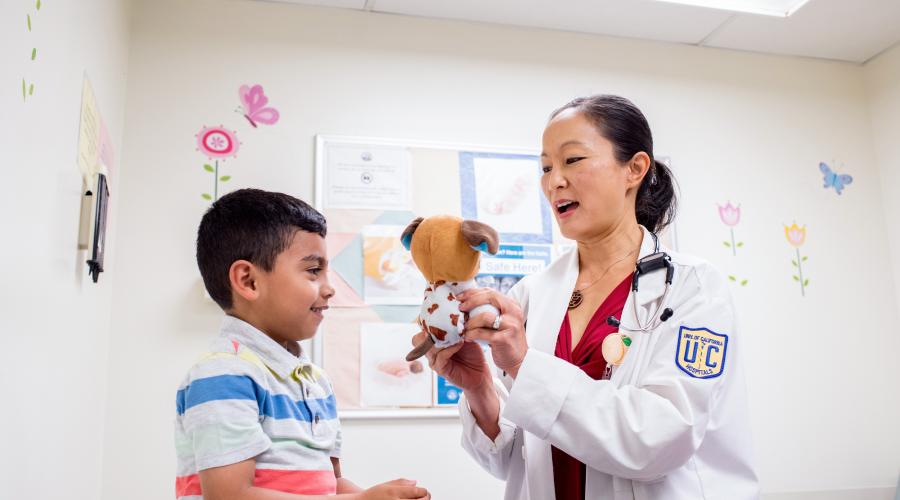 Anda Kuo, MD, professor of Pediatrics at UCSF, cares for patient Oswaldo Estrada in the pediatric clinic at ZSFG. Photo by Barbara Ries