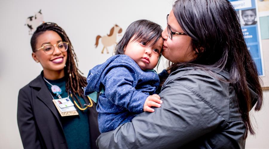 Former Resident Physician Jessica Williams, MD, meets with Mayra Vazquez and her son 8-month old Lucas Vazquez in the pediatric clinic at ZSFG.