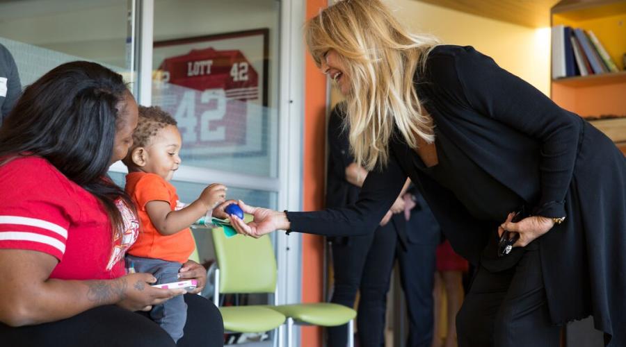 A child and his mother play with an adult at UCSF Benioff Children's Hospital